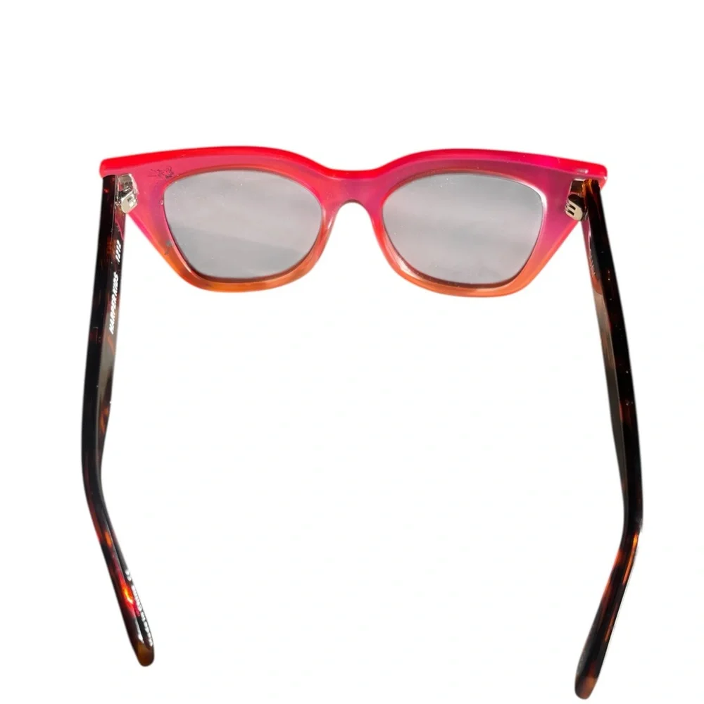 Quay Harper Kids cat-eye sunglasses with coral pink and smoke lenses.